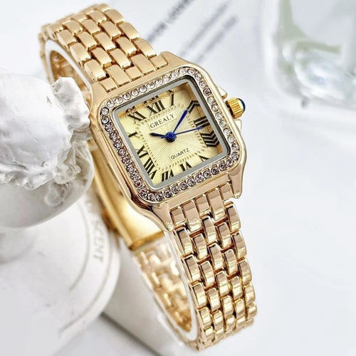 Gold wristwatch with decorative case on a gold background